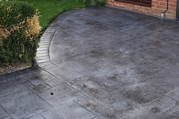 Completed Burbank concrete driveway installation with proper control joints and broom finish